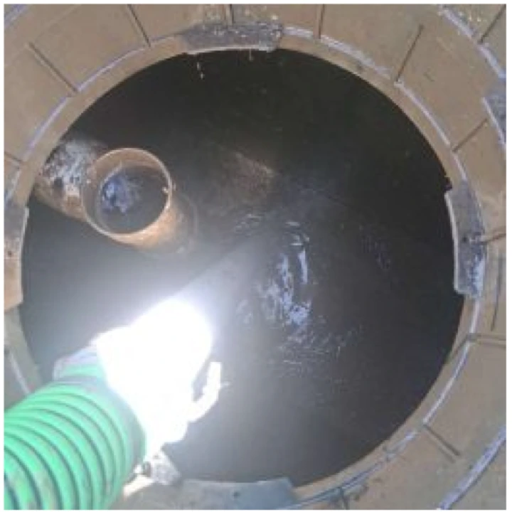 Photo from the completed septic tank pumping job showing service in progress.