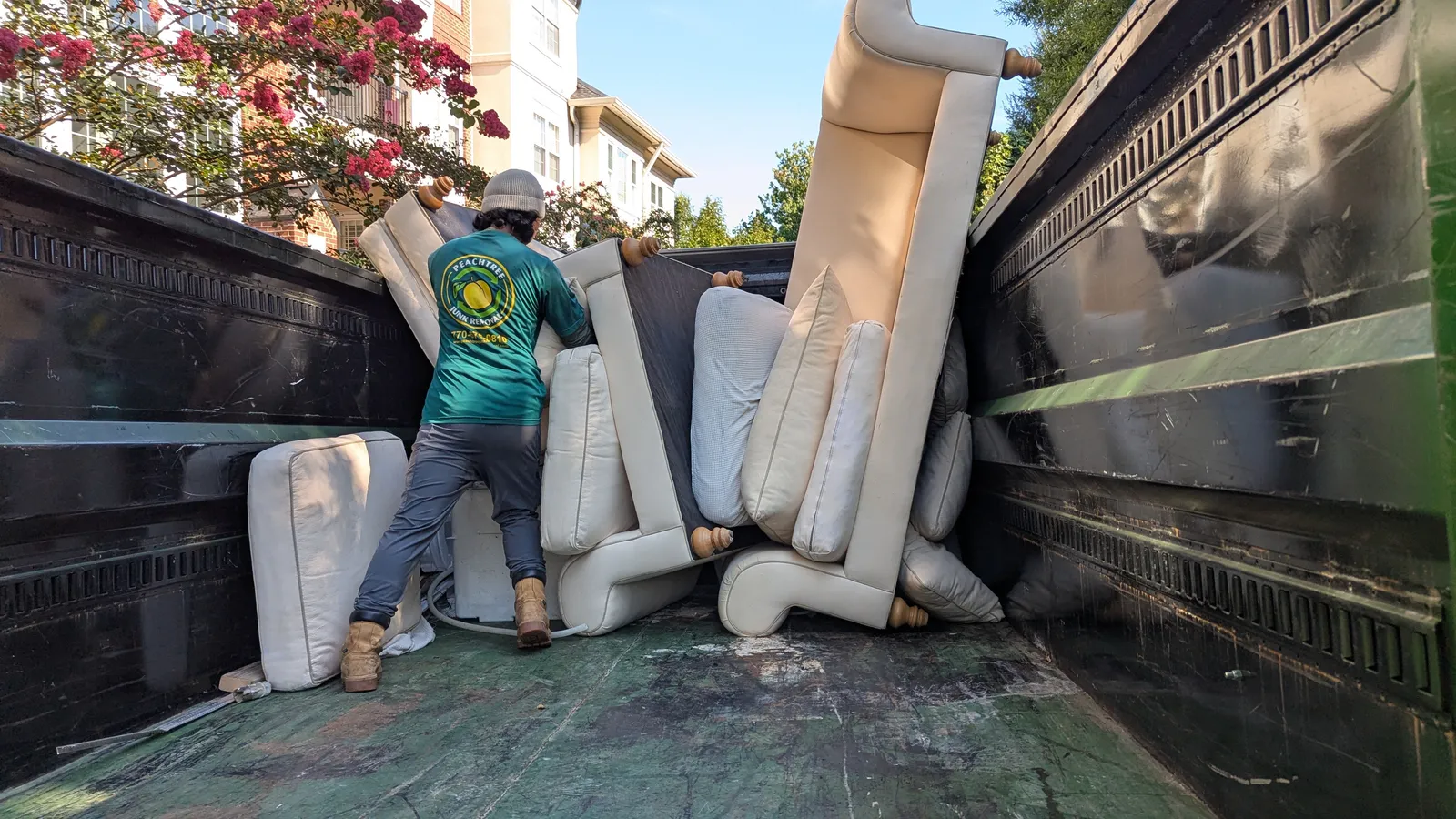 Peachtree Junk Removal crew loading a couch into their truck in Atlanta.